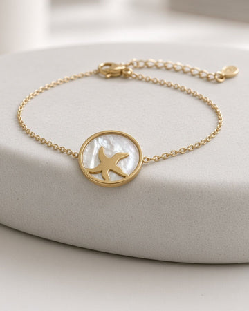 golden bracelet with starfish in seashell